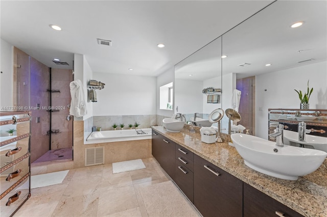 bathroom featuring separate shower and tub and vanity