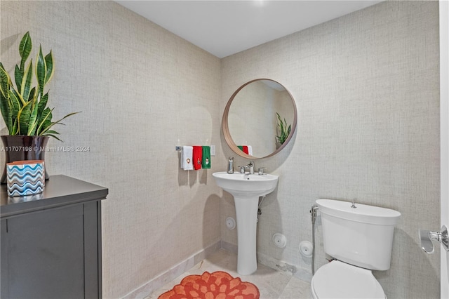 bathroom with tile patterned flooring, toilet, and sink