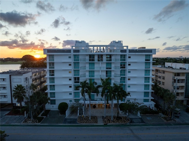 outdoor building at dusk featuring a water view