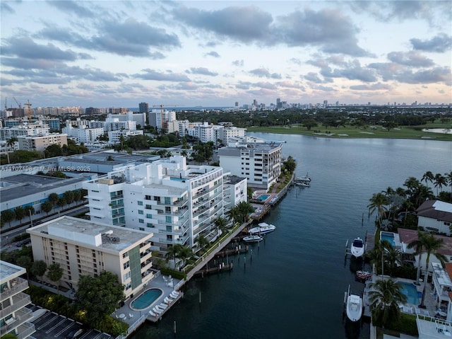 birds eye view of property featuring a city view and a water view