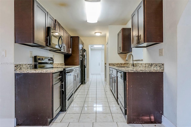 kitchen with light stone countertops, dark brown cabinetry, sink, black appliances, and light tile patterned floors