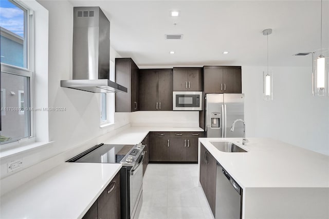 kitchen featuring appliances with stainless steel finishes, sink, plenty of natural light, and wall chimney range hood