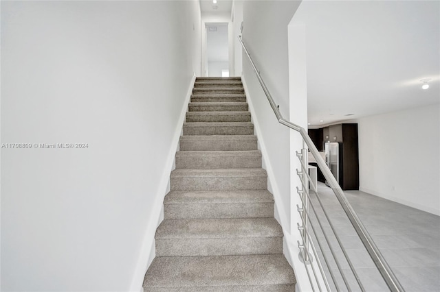 stairway featuring concrete floors