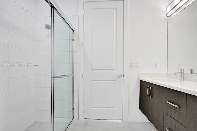 bathroom featuring tile patterned flooring, vanity, and walk in shower