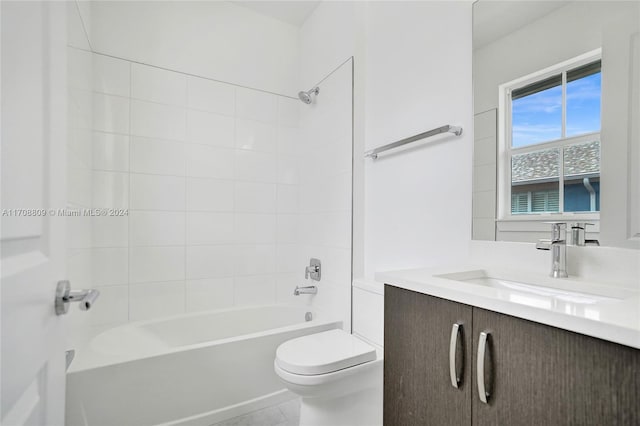 full bathroom with tile patterned flooring, tiled shower / bath combo, toilet, and vanity