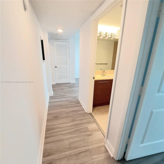 hallway featuring light hardwood / wood-style floors and sink