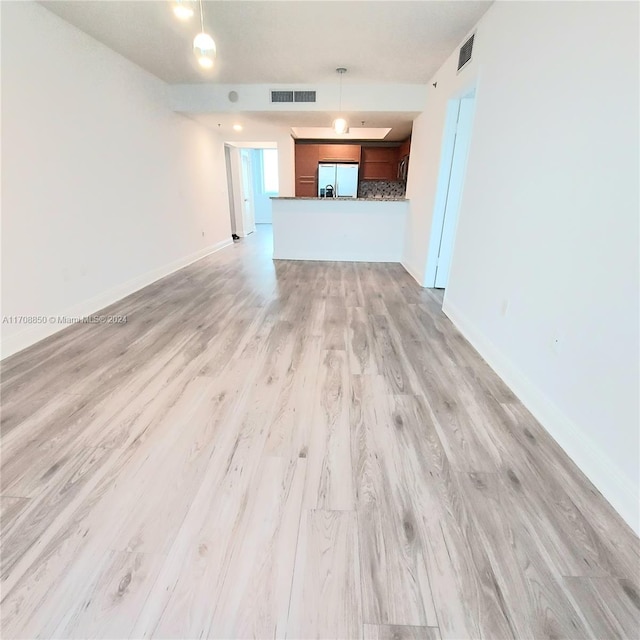 unfurnished living room featuring light hardwood / wood-style floors