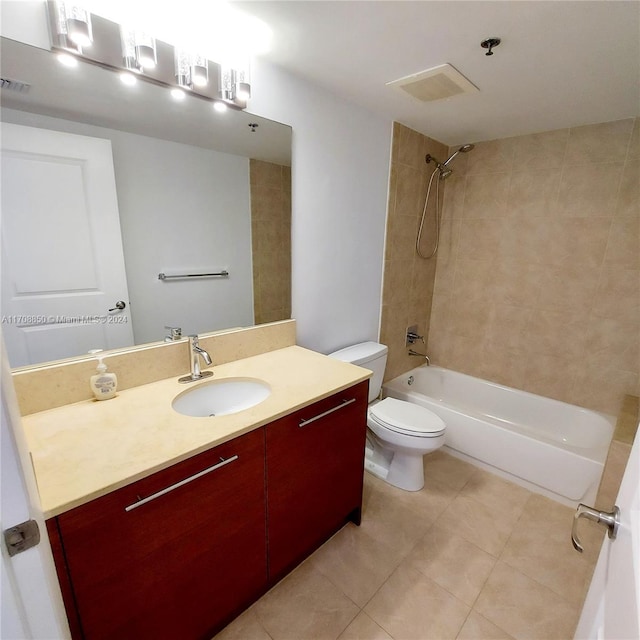 full bathroom featuring tile patterned floors, vanity, tiled shower / bath combo, and toilet