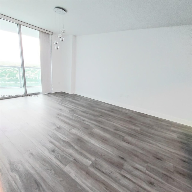 unfurnished room with a textured ceiling and hardwood / wood-style flooring