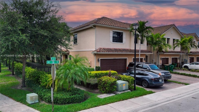 mediterranean / spanish-style home with a garage