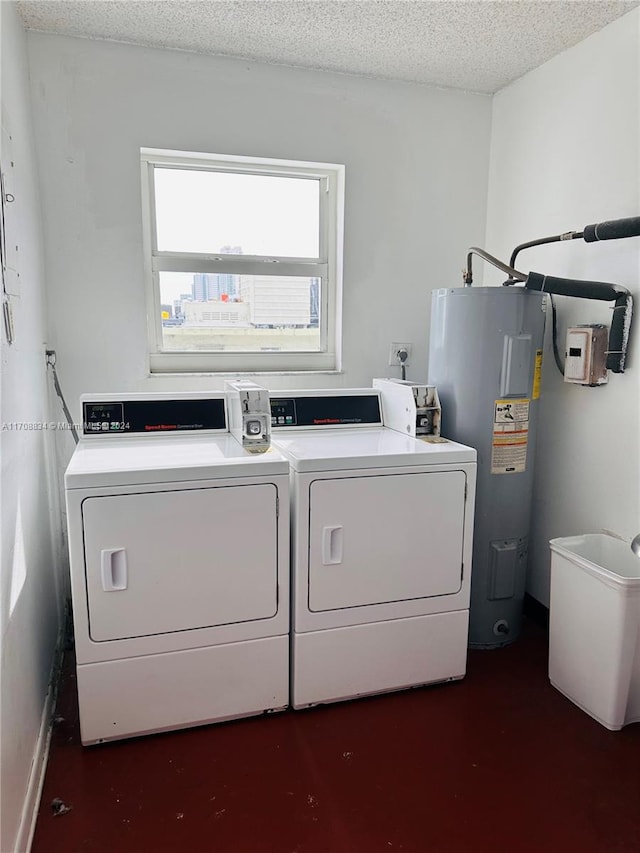 washroom featuring independent washer and dryer, a textured ceiling, and water heater