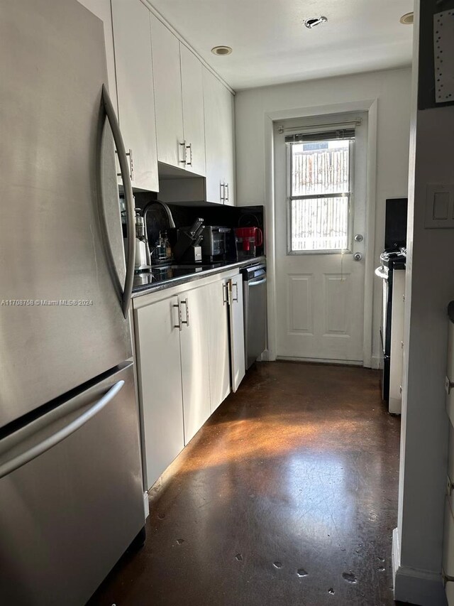 kitchen featuring white cabinets, appliances with stainless steel finishes, and sink