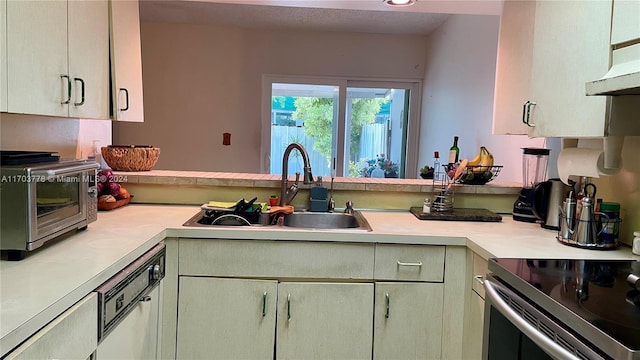 kitchen featuring kitchen peninsula, appliances with stainless steel finishes, ventilation hood, and sink