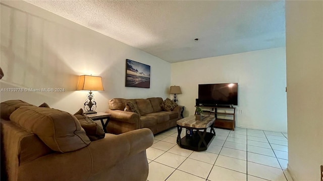 living room featuring light tile patterned floors and a textured ceiling