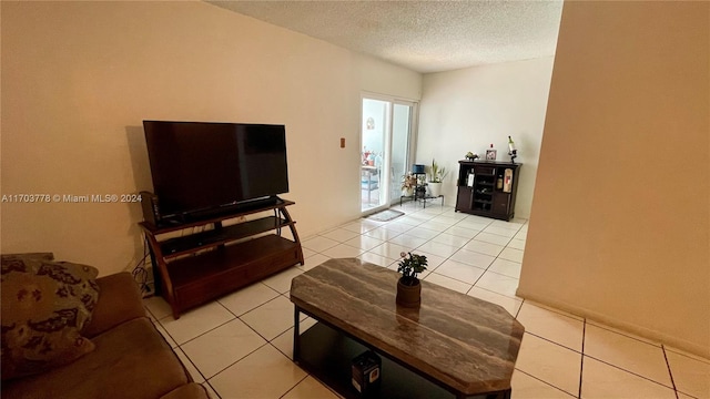 living room with light tile patterned floors and a textured ceiling