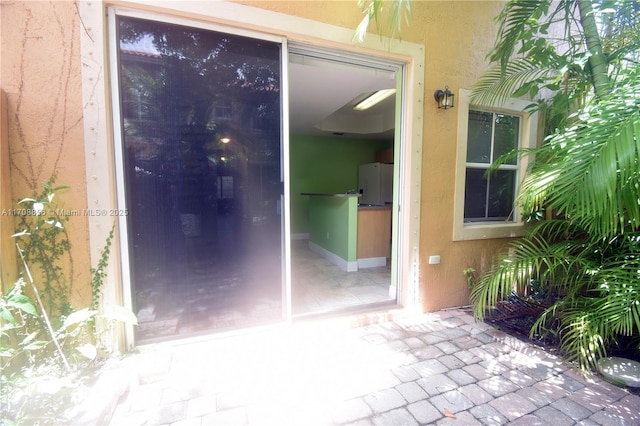 entrance to property featuring a patio