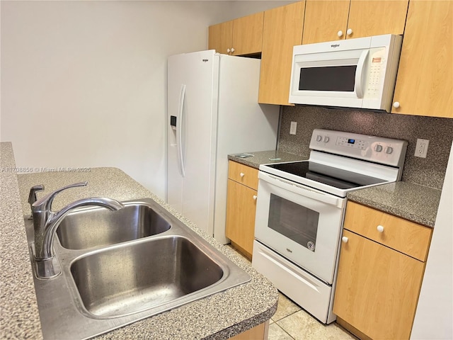 kitchen featuring tasteful backsplash, white appliances, light tile patterned flooring, and sink