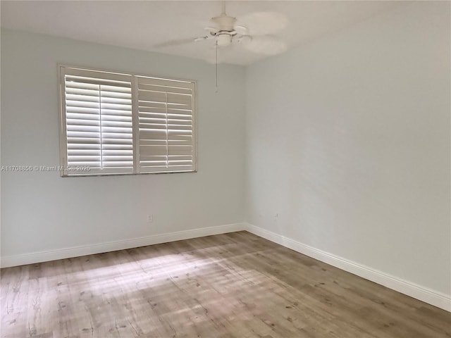 empty room featuring hardwood / wood-style flooring and ceiling fan