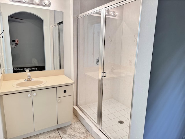 bathroom featuring vanity and a shower with shower door