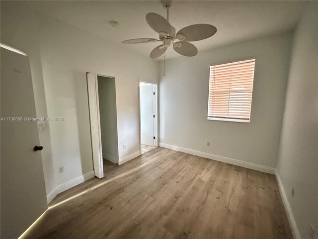 unfurnished bedroom with ceiling fan and light hardwood / wood-style floors