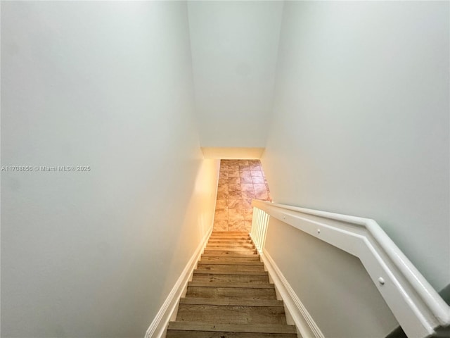 stairs featuring hardwood / wood-style floors