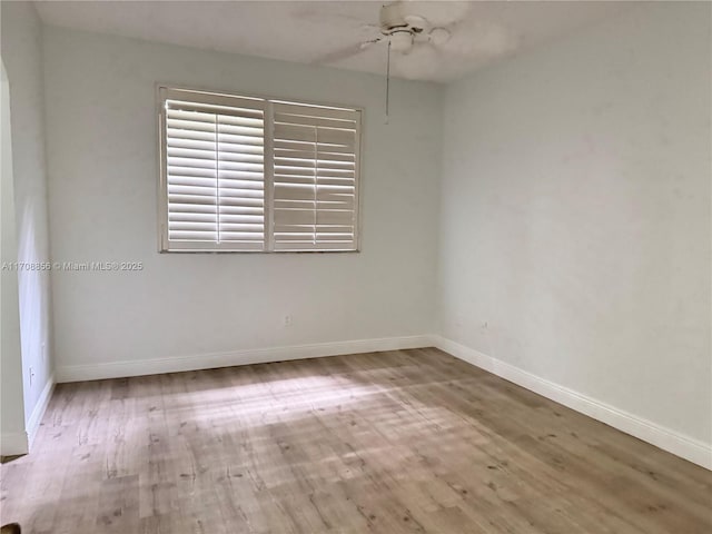 spare room with wood-type flooring and ceiling fan