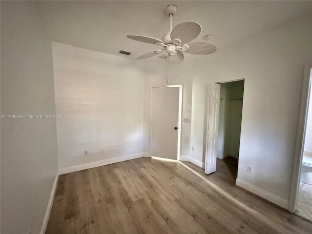 empty room with wood-type flooring and ceiling fan