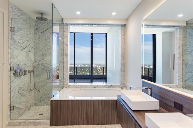 bathroom with vanity and separate shower and tub