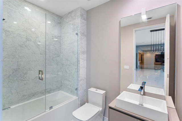 full bathroom with vanity, combined bath / shower with glass door, and toilet