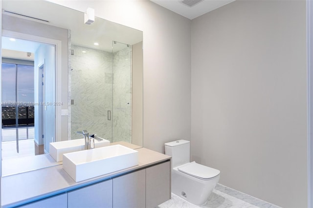 bathroom with an enclosed shower, vanity, and toilet