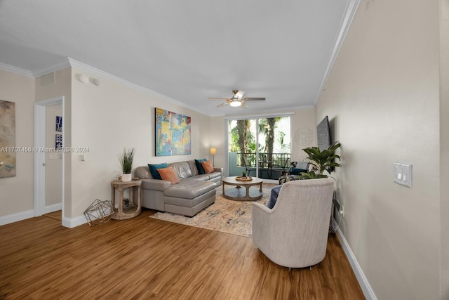 living room with hardwood / wood-style flooring, ceiling fan, and ornamental molding