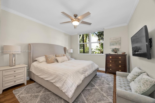 bedroom featuring ceiling fan, hardwood / wood-style floors, and crown molding