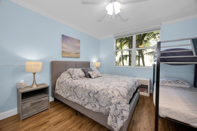 bedroom featuring wood-type flooring, ceiling fan, and crown molding