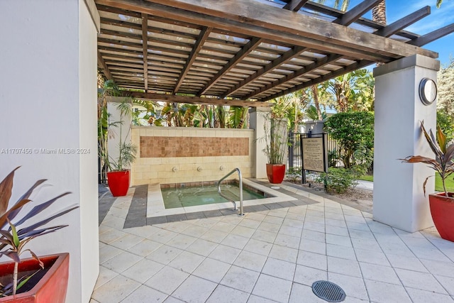 view of patio / terrace featuring an in ground hot tub and a pergola