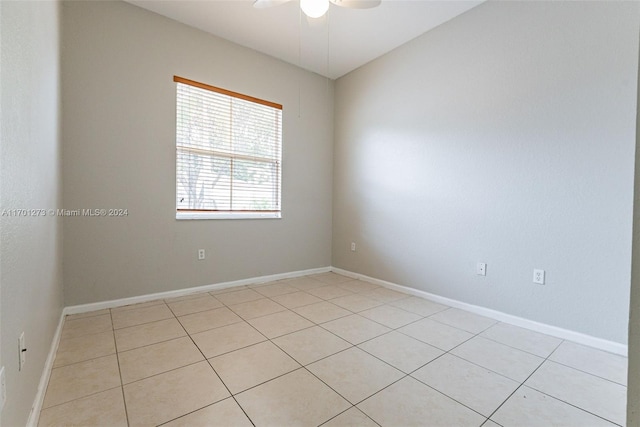 empty room with light tile patterned floors and ceiling fan