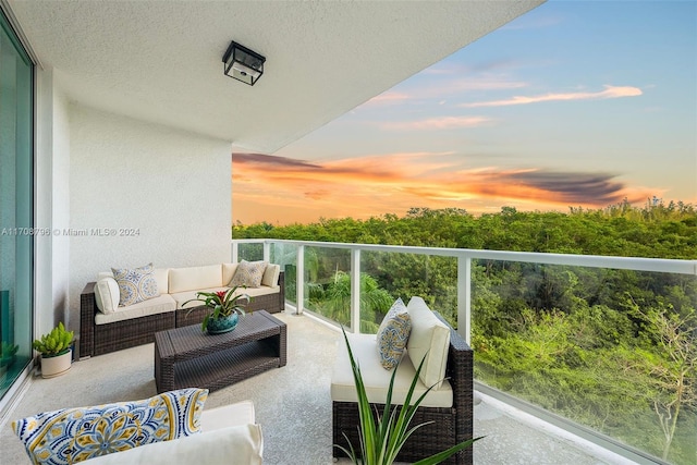 balcony at dusk featuring outdoor lounge area