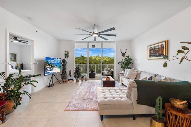 tiled living room with ceiling fan and expansive windows