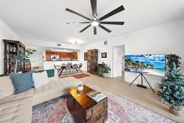 tiled living room with ceiling fan