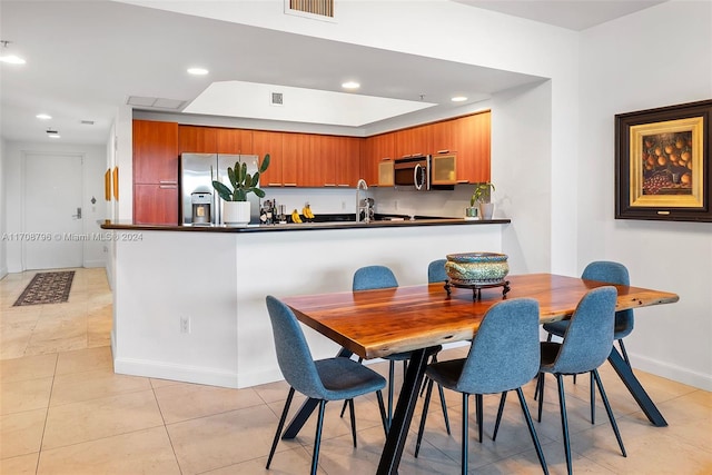 tiled dining area with sink