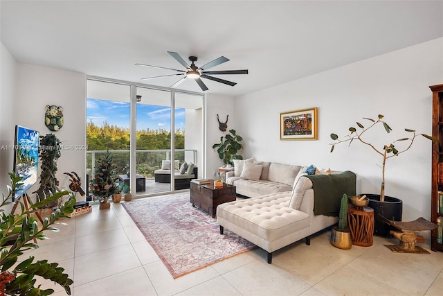 living room with ceiling fan, expansive windows, and light tile patterned flooring