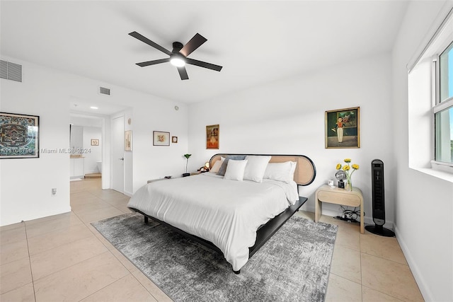 tiled bedroom with ceiling fan