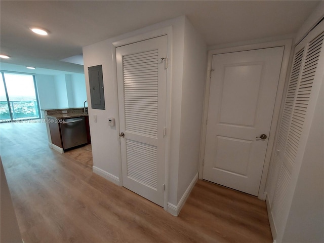 hall with electric panel and light hardwood / wood-style flooring