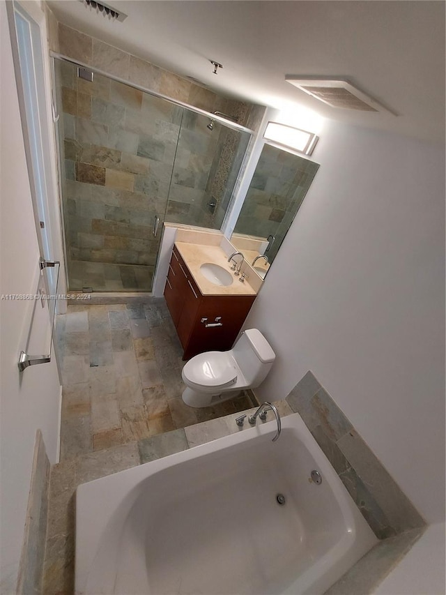 full bathroom featuring vanity, independent shower and bath, and toilet