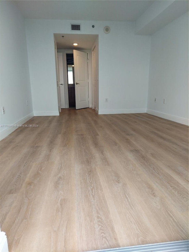 empty room with light hardwood / wood-style floors