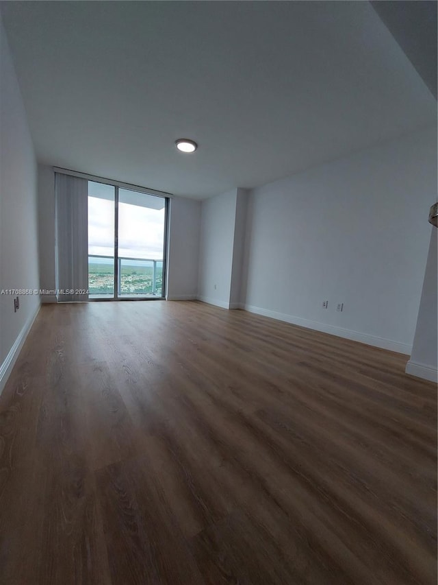 spare room featuring dark hardwood / wood-style flooring