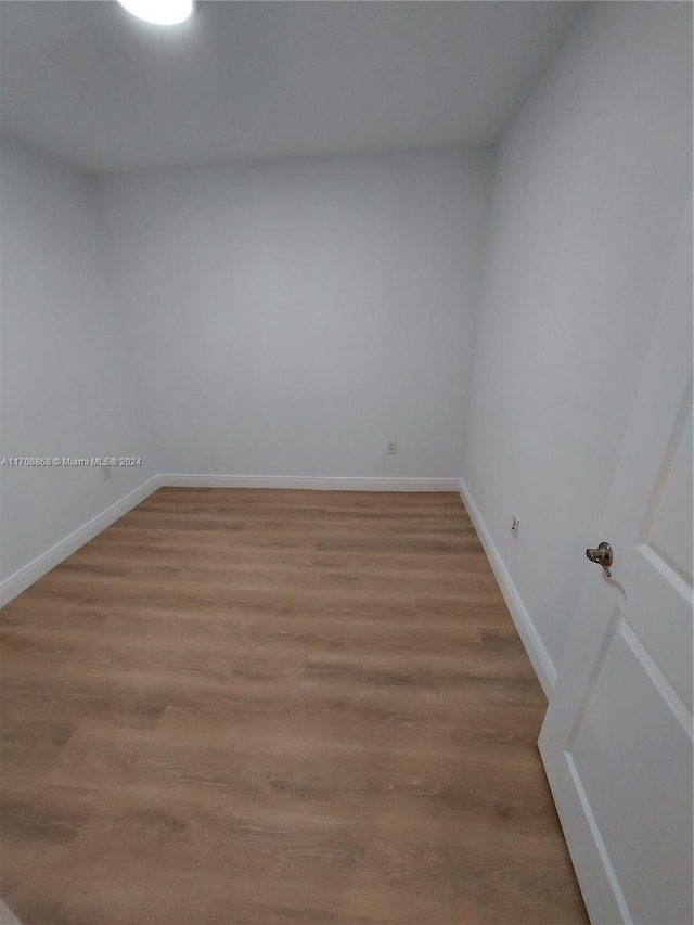 empty room with hardwood / wood-style flooring