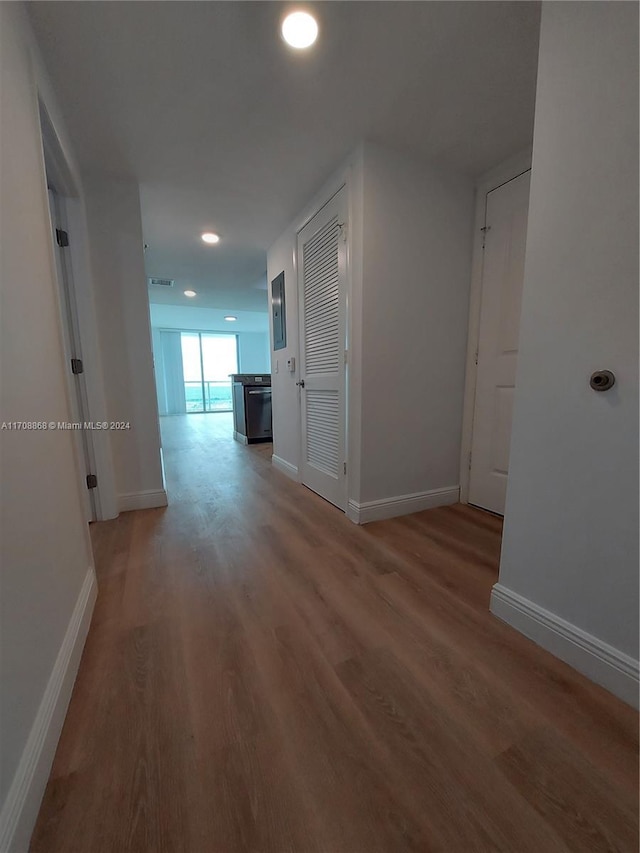 hall with hardwood / wood-style floors