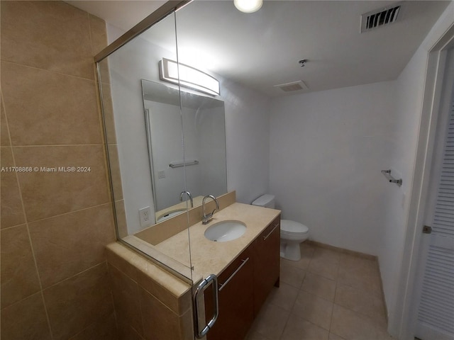 bathroom featuring tile patterned flooring, vanity, and toilet