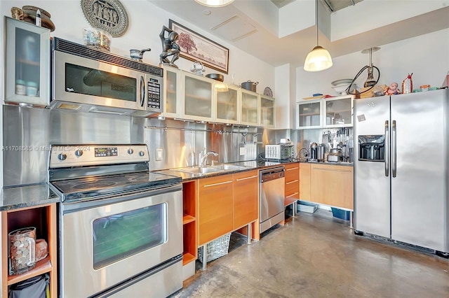 kitchen with sink, stainless steel appliances, concrete floors, decorative light fixtures, and decorative backsplash