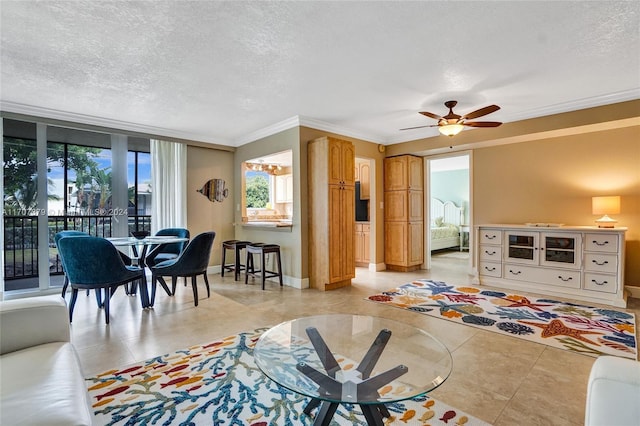 tiled living room with ceiling fan, crown molding, and a textured ceiling